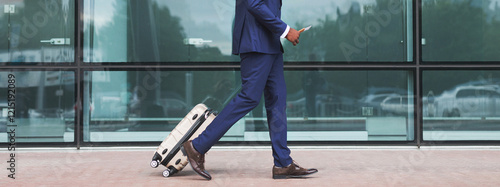 Obraz na plátně Unrecognizable Man With Bag And Suitcase Walking In Airport Terminal, Young Male On His Way To Flight Boarding Gate, Ready For Business Travel Or Vacation Journey, Cropped, Copy Space