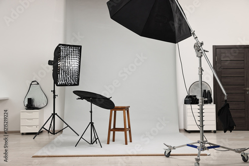 Professional lighting equipment setup in modern photo studio