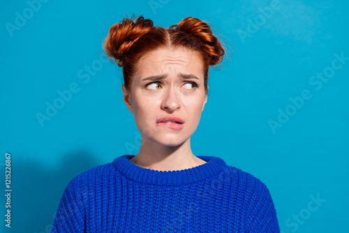Obraz na płótnie Young woman with red hair wearing blue sweater showing perplexed expression on c