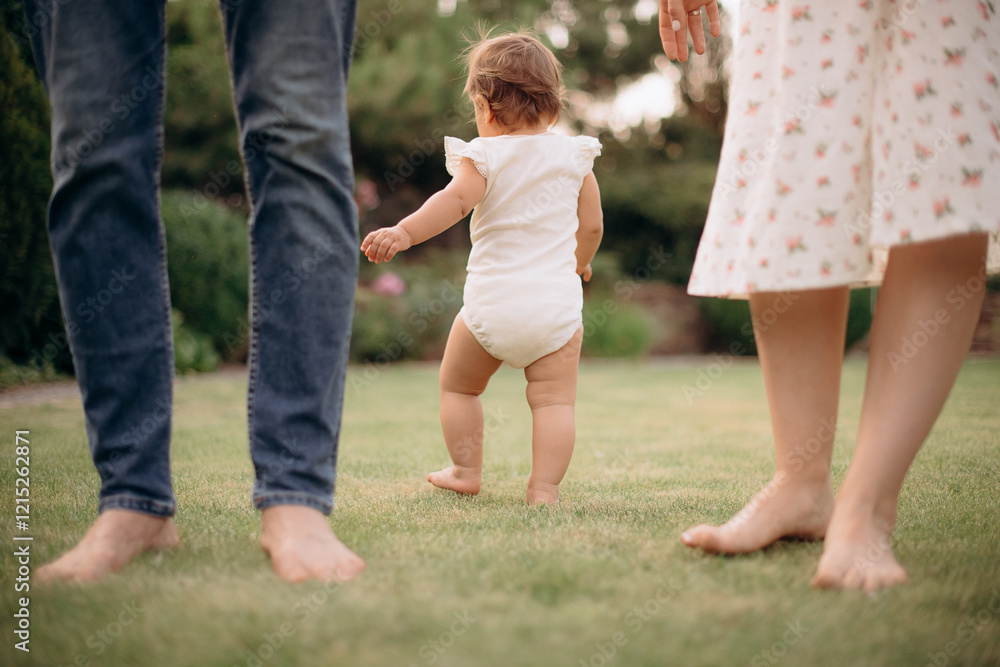 family walking in the summer park. father and mother with little baby family walking in the summer park. father and mother with little baby