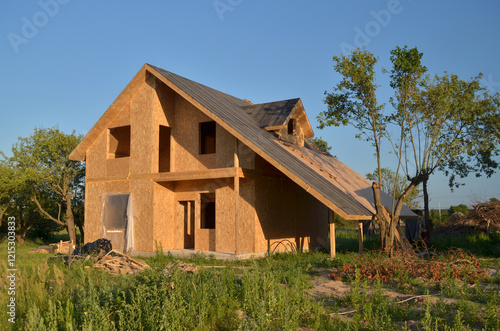 Construction of a new energy-efficient SIP house with a timber frame. Unfinished Wood residential building of panelized wall in country area. photo