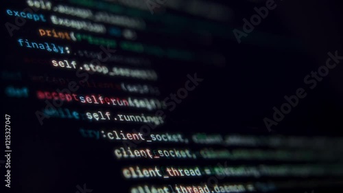 Close up of programming code running on dark computer screen. Programming and coding concept.