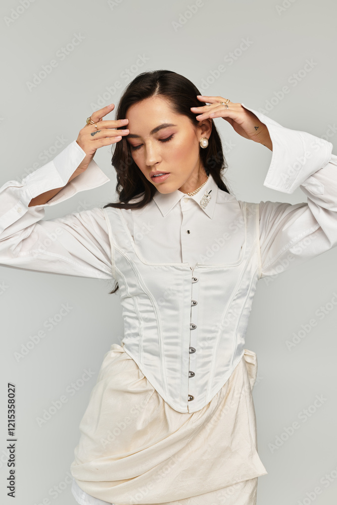 Beautiful woman showcases a chic fashion sense while striking a captivating pose in soft lighting. Beautiful woman showcases a chic fashion sense while striking a captivating pose in soft lighting.