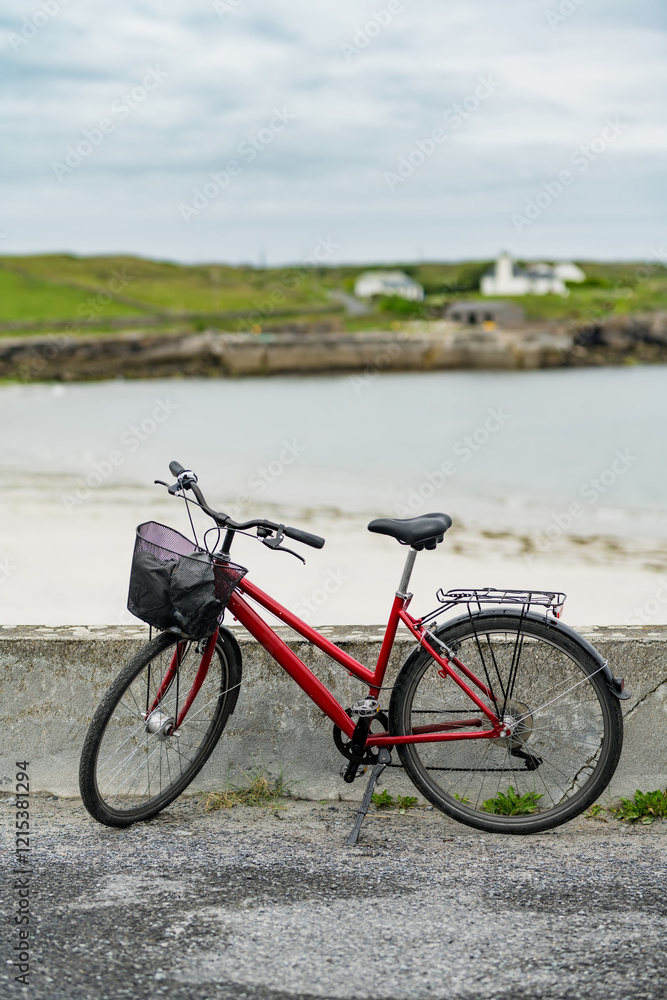 Bike parked on Inishmore, the largest of the Aran Islands in Galway Bay, Ireland. Renting a bicycle is the most popular way to get around Inis Mor. Bike parked on Inishmore, the largest of the Aran Islands in Galway Bay, Ireland. Renting a bicycle is the most popular way to get around Inis Mor.