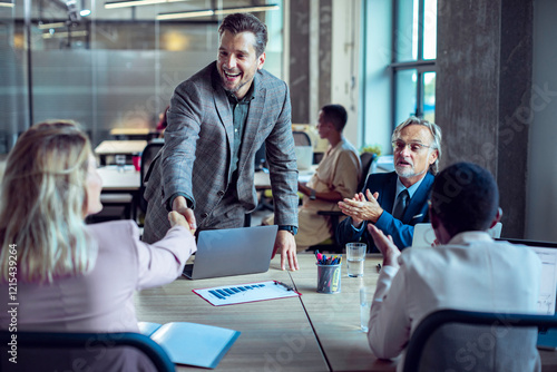 Business professionals shaking hands during a team meeting photo