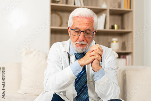 Wallpaper Mural Sad tired mature senior male doctor in medical uniform in hospital or doctor office. Unhappy General Practitioner GP therapist professional healthcare expert in clinic. Healthcare concept Torontodigital.ca