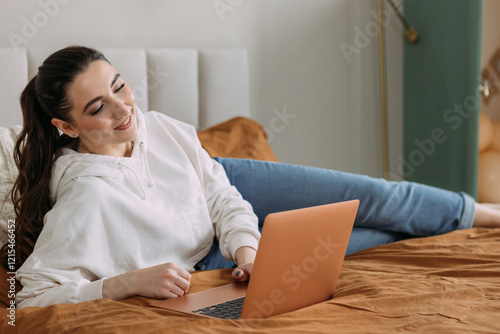 young girl working online at home using a laptop