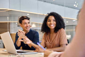 Professional employees company board discussing project plan in office consulting corporate client on financial investment. Happy young diverse people executive team working together at group meeting.