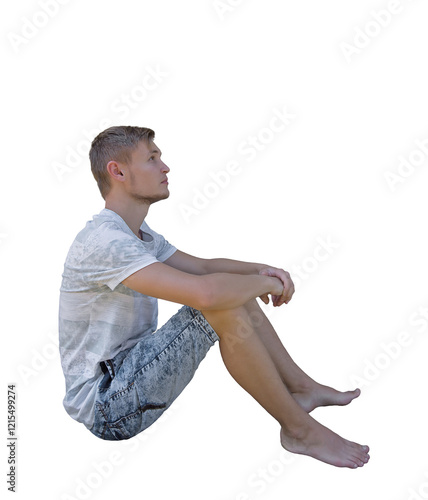 Pensive young man seated down looking up isolated over transparent background. Side view full length portrait thoughtful boy sitting