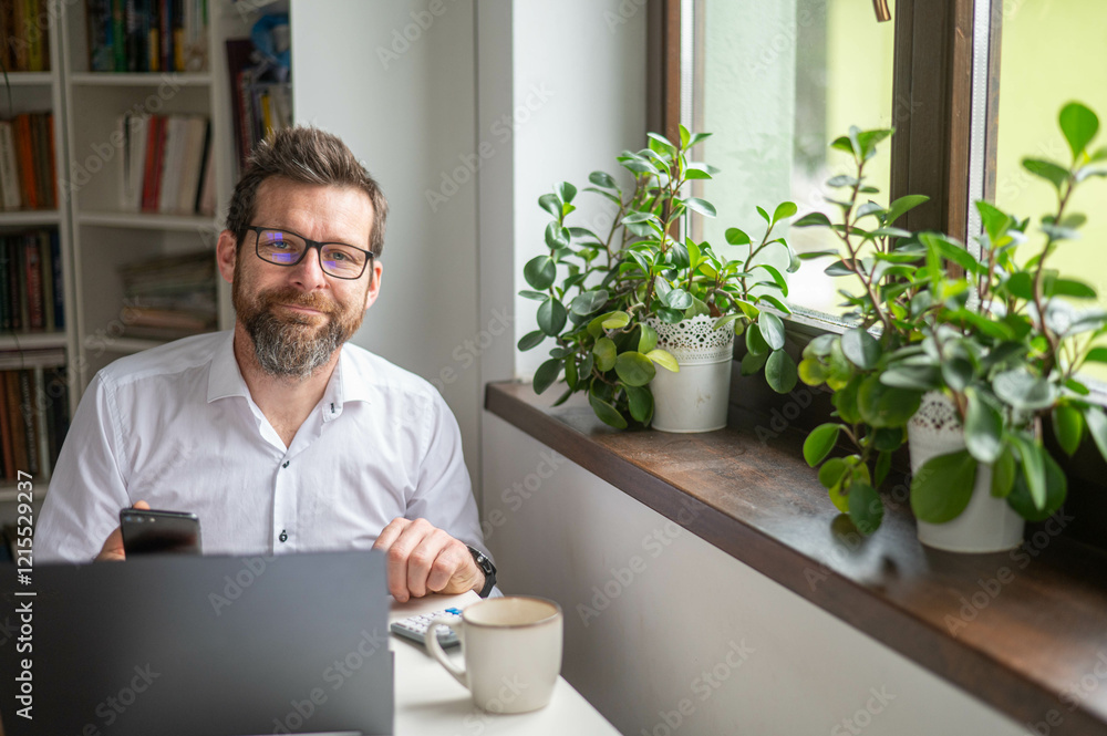 Millennial businessman working at desk in office Millennial businessman working at desk in office
