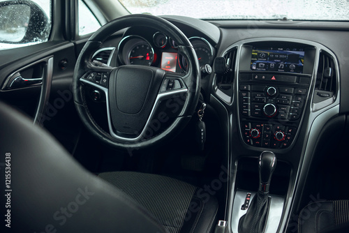 Interior view of the dasboard and steering wheel of the modern car at winter time