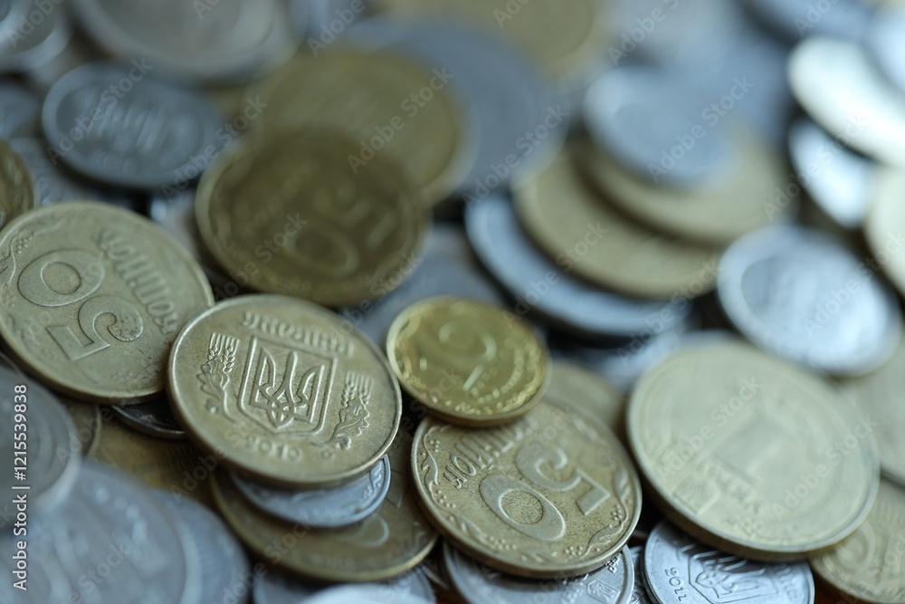 Metal coins of Ukraine of different denominations are scattered. Money texture, business background. Metal coins of Ukraine of different denominations are scattered. Money texture, business background.