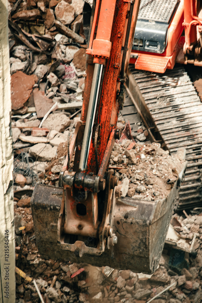 Fototapeta premium Excavator removing debris from a demolition site.