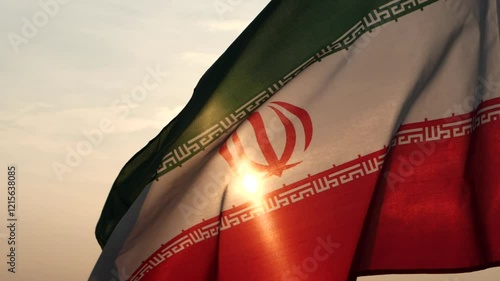 Close up Iran flag waving in the wind against sunset, beautiful cloud sky, outdoor background. Concept of Iran national flag, Iranian, Islamic Republic of Iran, Emblem, Persian, Iranian, War, Freedom