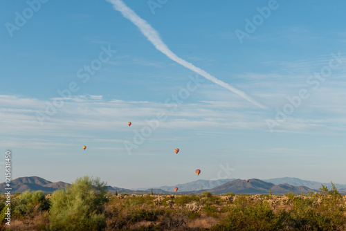 Multiple hot air balloons at a balloon event in Scottsdale Arizona USA on a beautiful morning with a blue sky