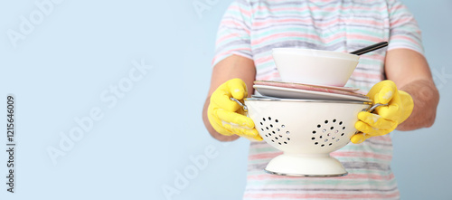 Young man with dirty dishes...