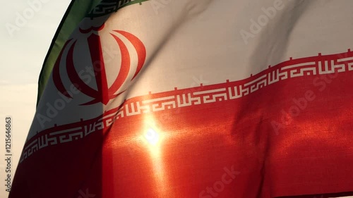 Close up Iran flag waving in the wind against sunset, beautiful cloud sky, outdoor background. Concept of Iran national flag, Iranian, Islamic Republic of Iran, Emblem, Persian, Iranian, War, Freedom