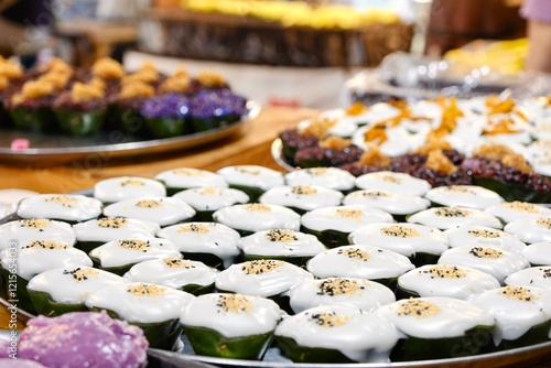 Khanom Tako at Khlong Lat Mayom, a floating market in Taling Chan, Bangkok, Thailand: a Thai dessert made from glutinous rice flour and coconut cream, served in a pandan leaf or banana leaf casing photo