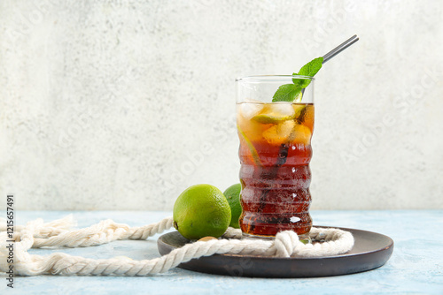 Canvas Print Plate with glass of cold Cuba Libre cocktail on blue table