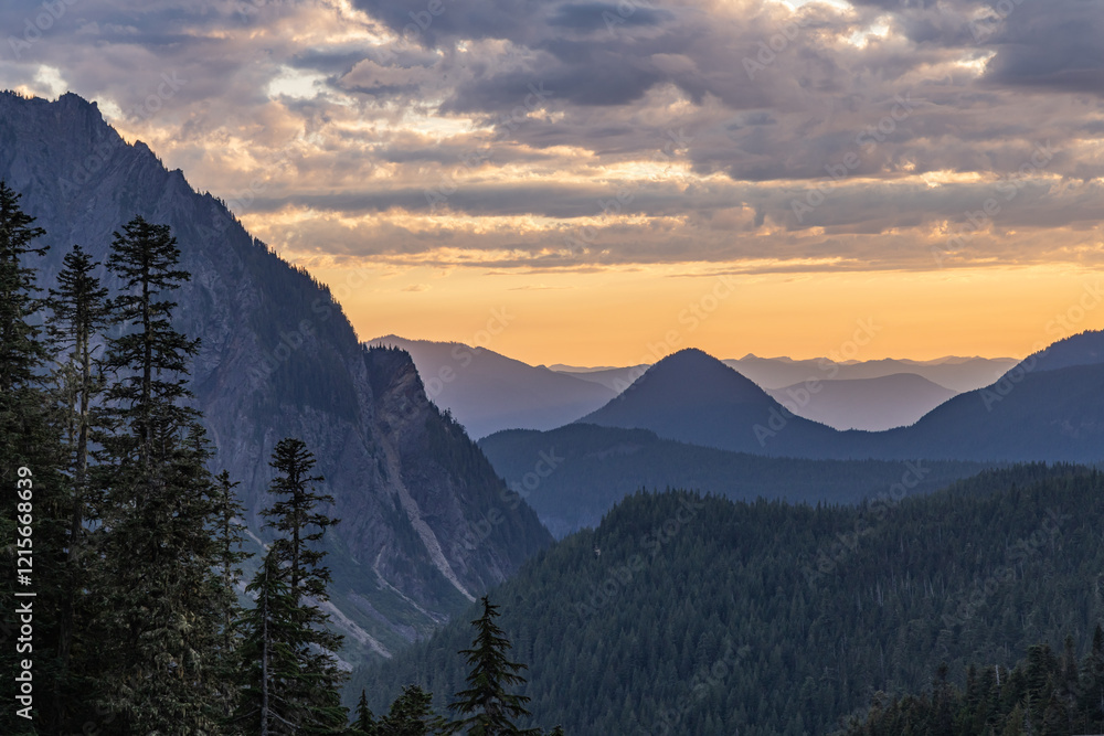 Obraz premium Looking down a mountain valley at sunset.