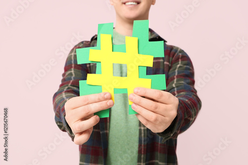 Man with hashtag signs on p...