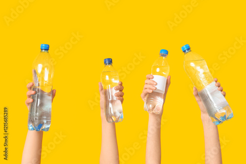 Multiple hands holding up p...