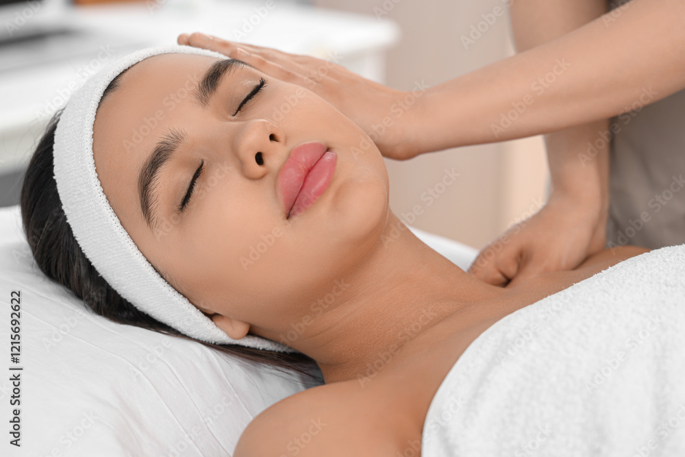 Beautiful woman getting facial massage in salon, closeup Beautiful woman getting facial massage in salon, closeup