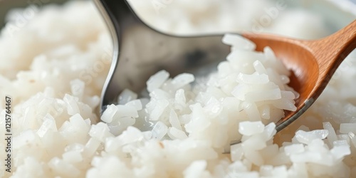 Close-up shot of a spoon digging into a fluffy cloud of sticky rice, sweet treat, creamy sauce photo