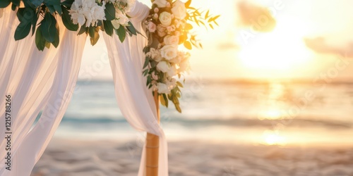 Beach wedding arch adorned with flowers at sunset. Golden hour sunset scene.