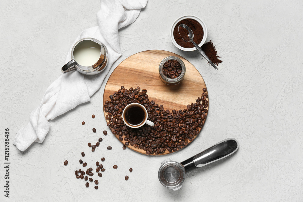 Naklejka premium Cup of coffee with portafilter, powder, beans and jug of milk on white background