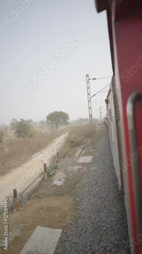 Train journey view, Railway tracks scene, Passenger train in motion, Scenic railway route, Indian railway tracks, Red train view, Train travel perspective stock video. photo