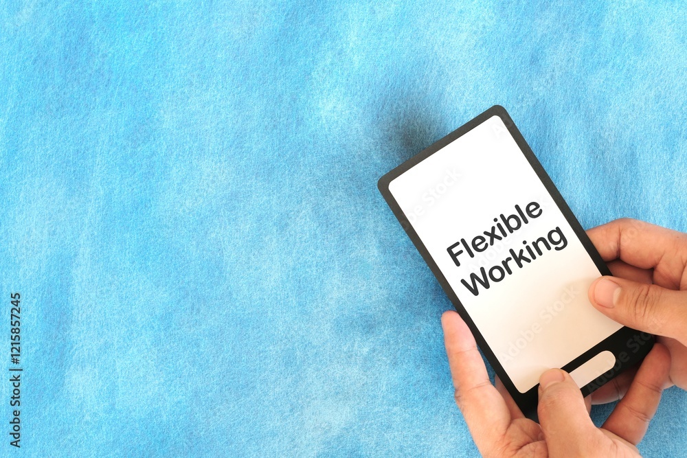 Human hand holding mobile phone with written phrase flexible work arrangement. Flexible work setup concept.