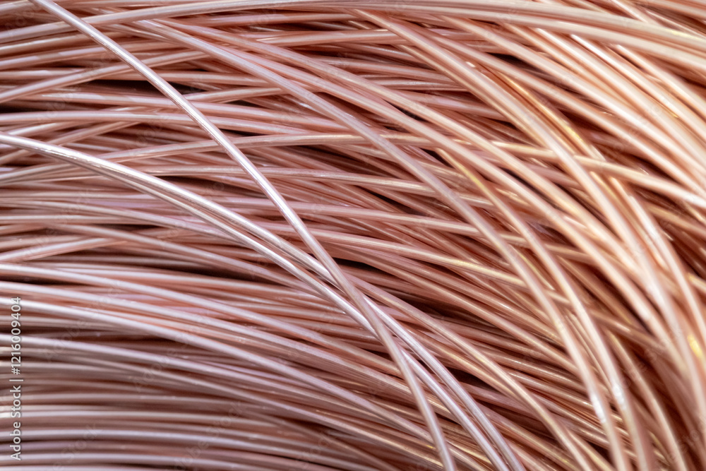 Close-up of coiled copper wires, showcasing their shiny surface and intricate overlapping pattern, captured in warm lighting.. Close-up of coiled copper wires, showcasing their shiny surface and intricate overlapping pattern, captured in warm lighting..
