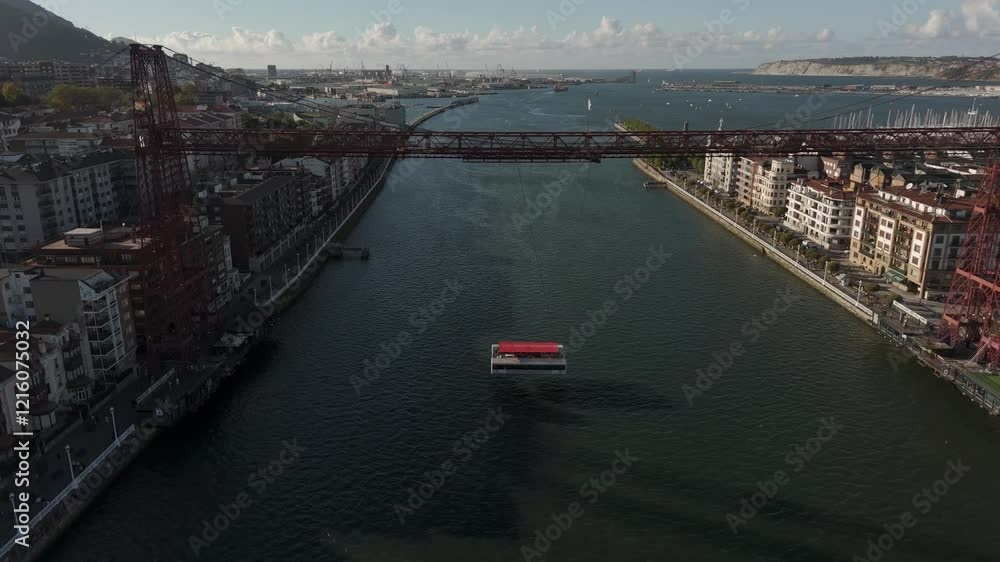 Vizcaya transporter bridge and its gondola linking Portugalete on left and Las Arenas towns in the right on Nervion River, Hanging bridge, Drone shot Vizcaya transporter bridge and its gondola linking Portugalete on left and Las Arenas towns in the right on Nervion River, Hanging bridge, Drone shot