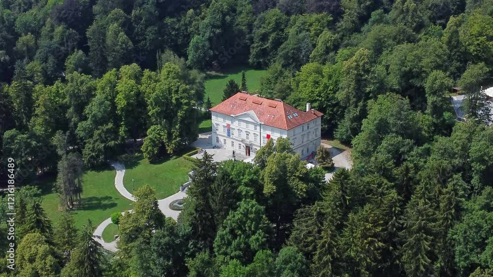 Aerial view of Castle Tivoli surrounded by dense green trees and pathways in Tivoli Park, Ljubljana, Slovenia. Aerial view of Castle Tivoli surrounded by dense green trees and pathways in Tivoli Park, Ljubljana, Slovenia.