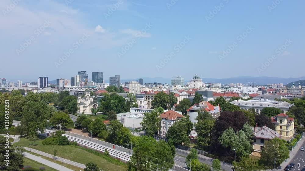 Aerial view of Ljubljana's cityscape blending historic and modern architecture with lush greenery and pathways, Slovenia. Aerial view of Ljubljana's cityscape blending historic and modern architecture with lush greenery and pathways, Slovenia.