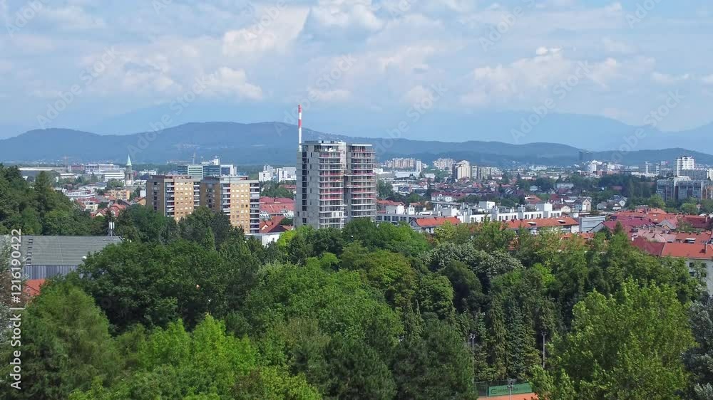 View of Ljubljana's city skyline with modern and historic buildings surrounded by greenery in Tivoli Park, Slovenia. View of Ljubljana's city skyline with modern and historic buildings surrounded by greenery in Tivoli Park, Slovenia.