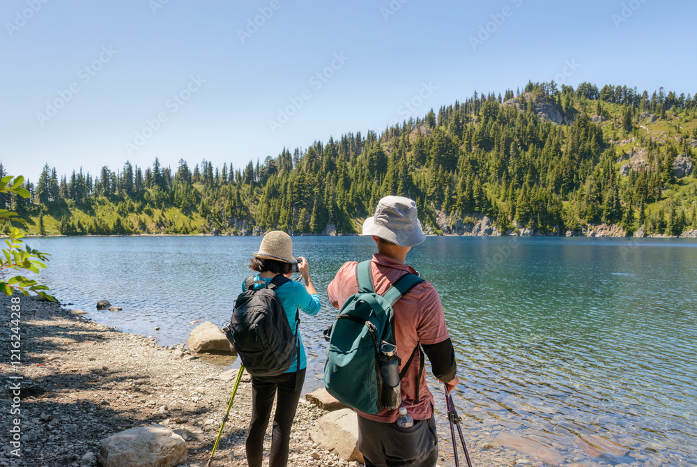 Tourists taking photos using smartphones of Summit Lake. Mount Rainier National Park. Washington State.