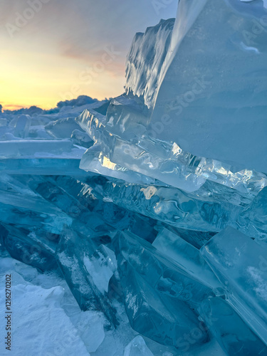 Obraz na plátne transparent blue ice hummocks against the background of the sunset sky in winter on Lake Baikal