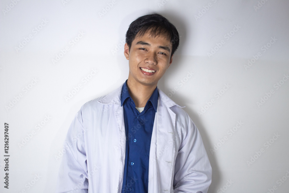 young researcher with his lab coat smiling happily young researcher with his lab coat smiling happily