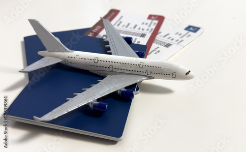 White blank model of passenger plane on passports with boarding pass 