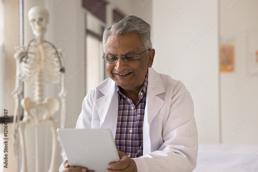 Digital devices in medicine. Happy smiling middle aged doctor healthcare consultant family therapist use tablet pc at clinic for online communication to support patient on distance read research news Digital devices in medicine. Happy smiling middle aged doctor healthcare consultant family therapist use tablet pc at clinic for online communication to support patient on distance read research news