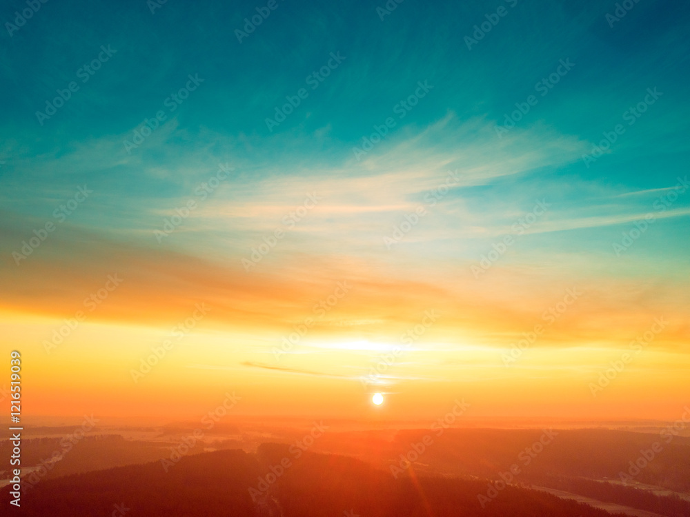 Beautiful dramatic evening sky over pine forest. Village in the forest during sunset. Aerial view
