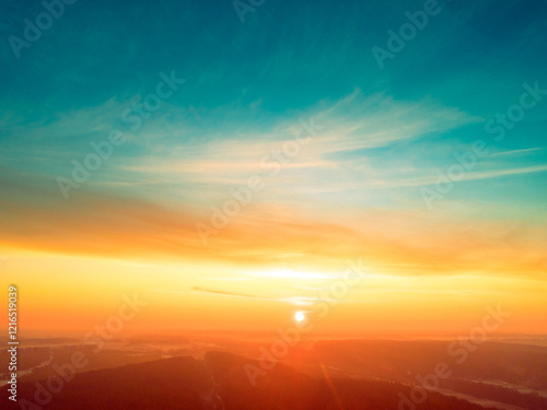 Obraz na płótnie Beautiful dramatic evening sky over pine forest. Village in the forest during sunset. Aerial view w salonie