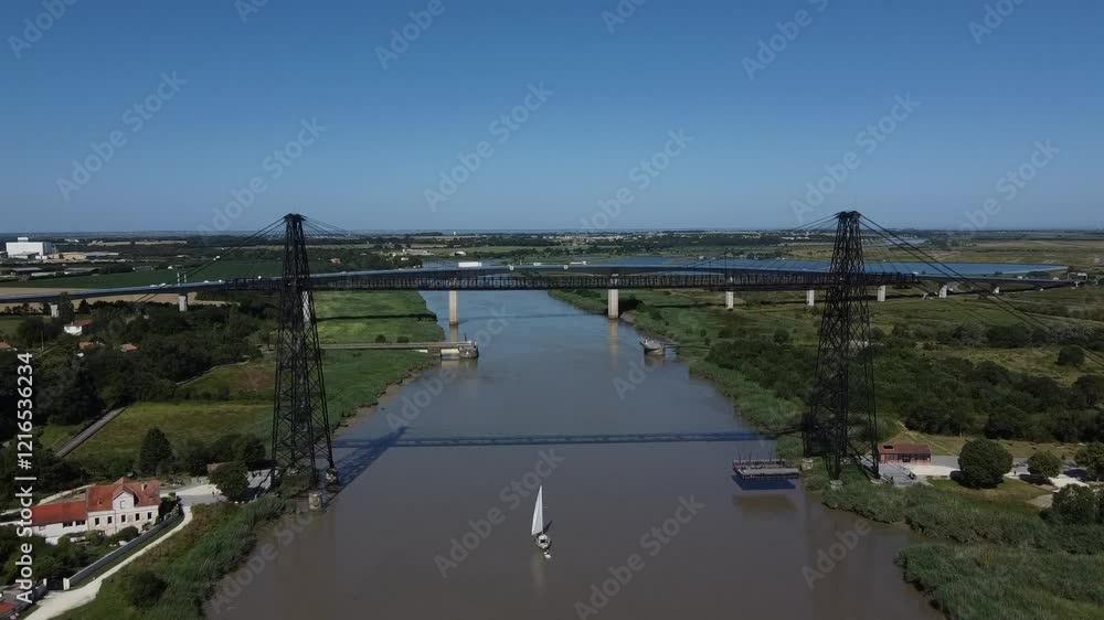 Aerial view of a sailboat approaching the Rochefort sur Mer transporter bridge, France Aerial view of a sailboat approaching the Rochefort sur Mer transporter bridge, France