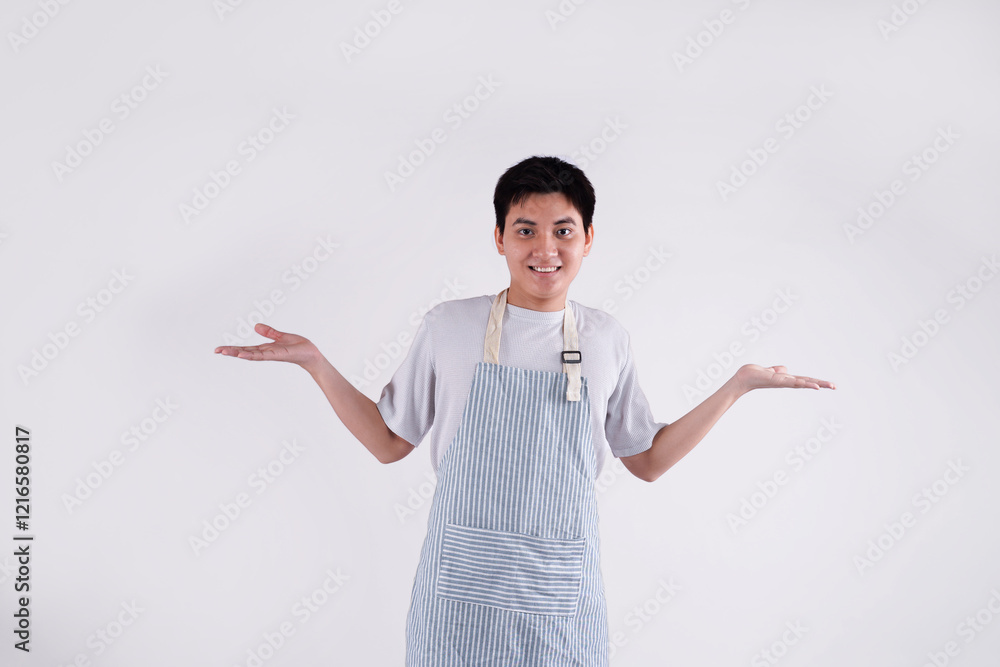 Portrait of young Asian man wearing apron and posing on white background Portrait of young Asian man wearing apron and posing on white background