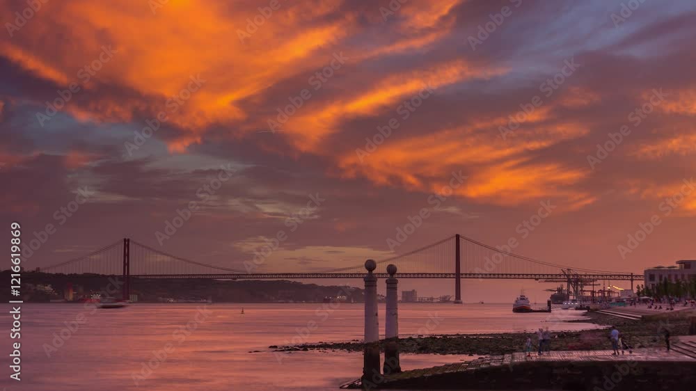 LISBON, PORTUGAL - JANUARY 19, 2025: Sunset over the river with a stunning view of the iconic bridge and vibrant sky at dusk LISBON, PORTUGAL - JANUARY 19, 2025: Sunset over the river with a stunning view of the iconic bridge and vibrant sky at dusk