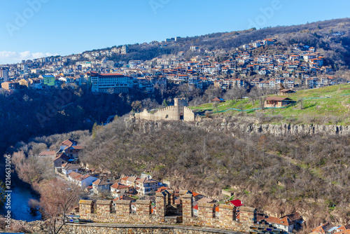 Tsarevets Fortress on a hill with a cloudy sky in the background