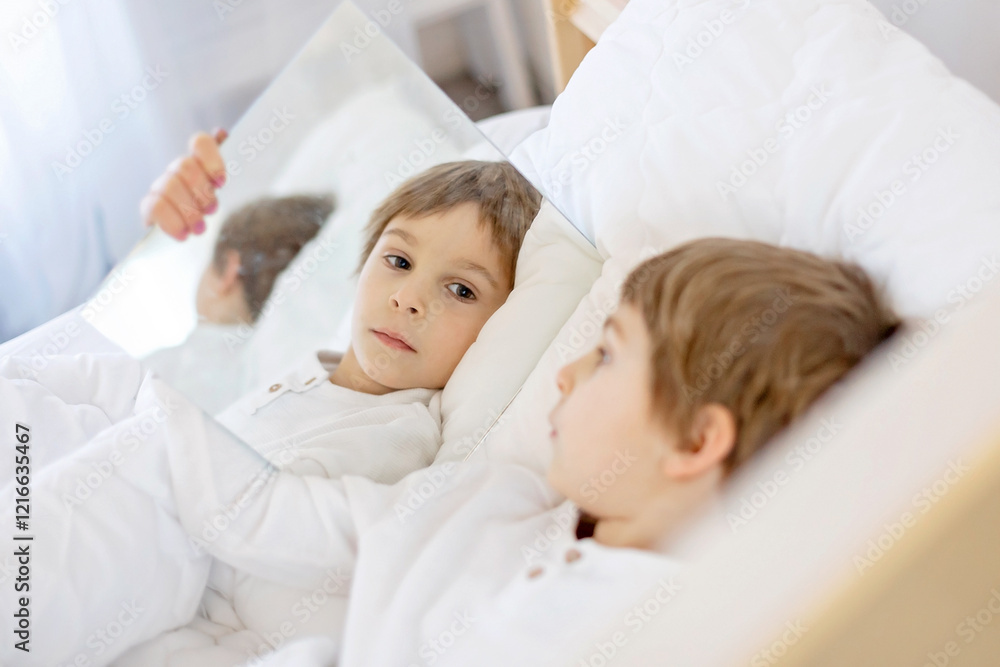Portrait with mirrors of a child, lying in bed, reflection of his face Portrait with mirrors of a child, lying in bed, reflection of his face