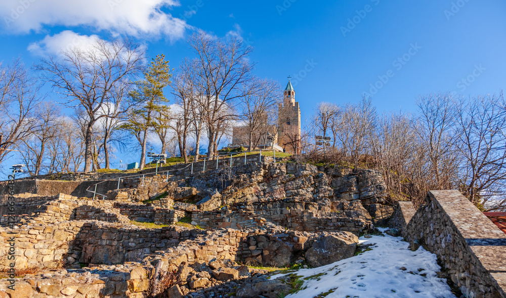 Tsarevets Fortress on a hill with a cloudy sky in the background
